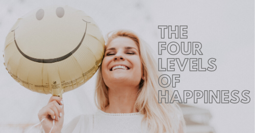 the-four-levels-of-happiness-woman smiling holding a balloon