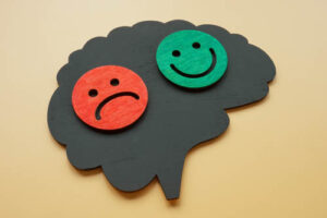 an icon showing a happy and sad face that could benefit from bipolar disorder therapy
