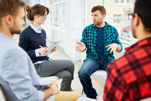 a group therapy session meets and people talk