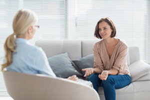 a person talks to a therapist about intensive outpatient treatment length