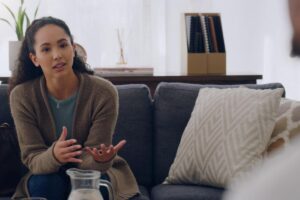 young woman who is learning how to ask for help with mental health by talking with her therapist