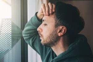 A distressed man thinking about co-occurring disorders examples