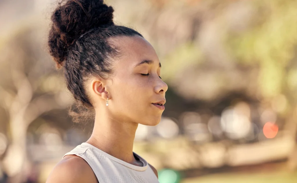 Morning Anxiety - woman in breathing meditation outdoors