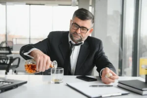 male employee drinking at the workplace - psychological dependence