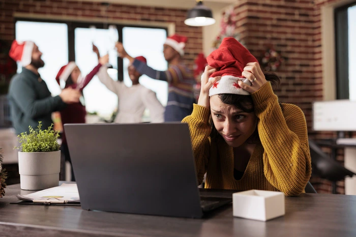 The Holiday Season - A Joyful Time or a Mountain to Climb - woman struggle during the holidays in the workplace